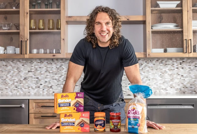Justin Gold stands with Rudi's Mountain Bakery products